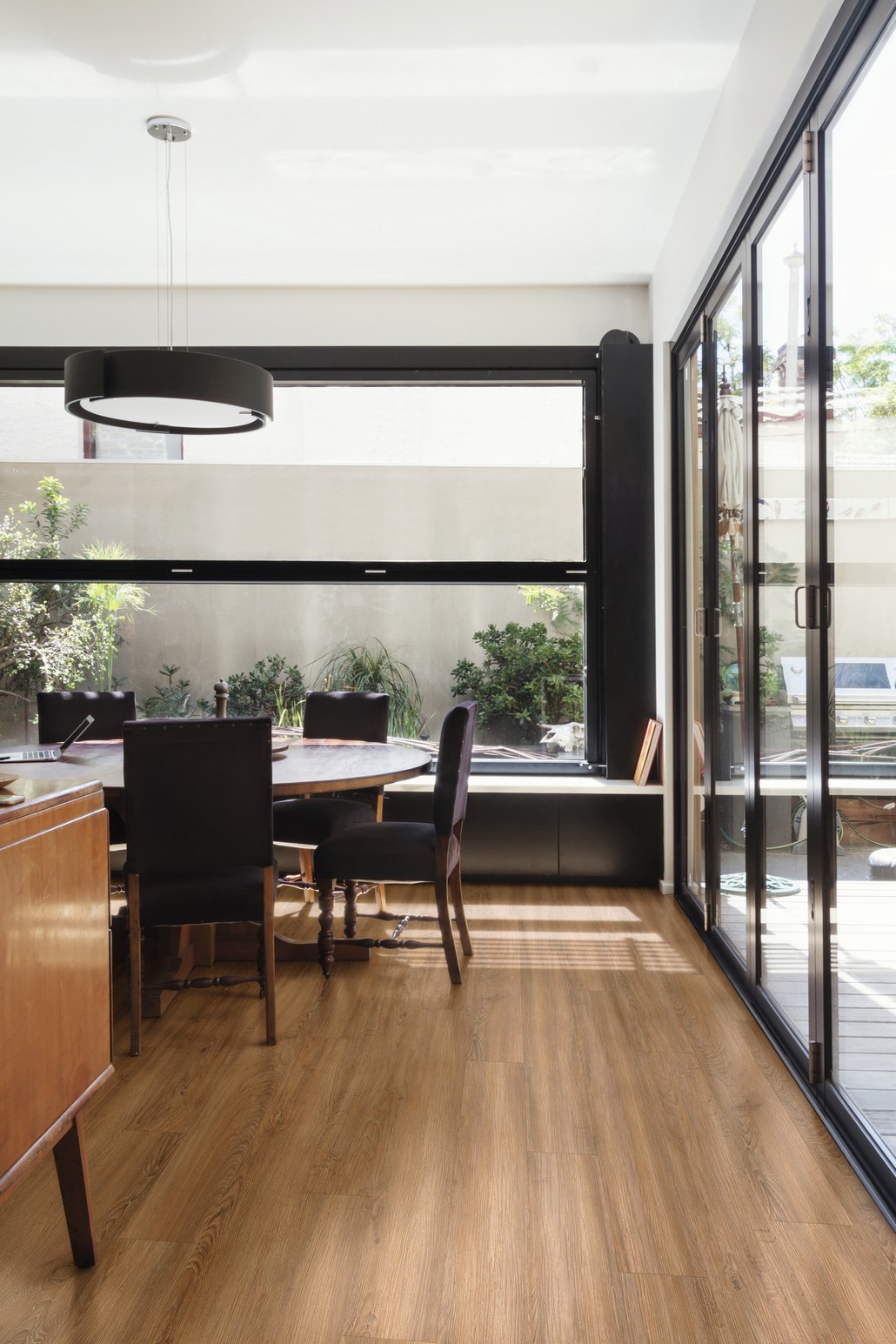 Modern dining room with polished concrete floor and glass bi fold doors